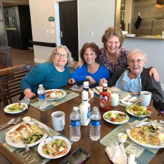 A group of women enjoying a meal together at a restaurant.