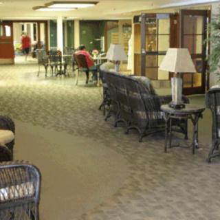 A spacious lobby area featuring wicker furniture and soft lighting.