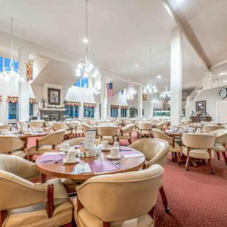 An elegant restaurant interior with neatly arranged tables and chairs, ready for guests.