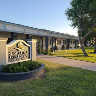 A well-maintained building with a welcoming sign surrounded by greenery.