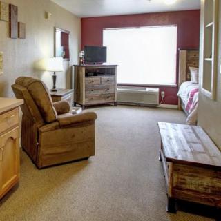 An inviting living room with cozy furnishings and a large window.