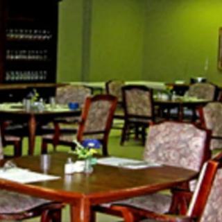 An empty dining area with neatly arranged tables and chairs in a restaurant.