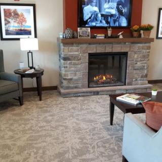 A cozy living room with a fireplace, TV, and comfortable seating.