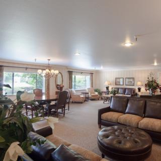 A spacious living room with comfortable sofas, a dining area, and elegant decor.
