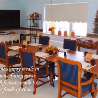 A cozy dining area designed for enjoying meals together, featuring a table set with place settings and warm decor.