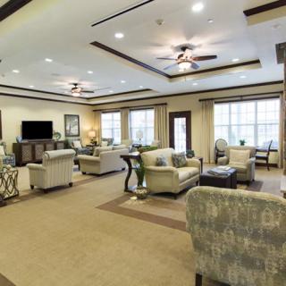 A spacious and elegantly designed living room with comfortable seating and ample natural light.