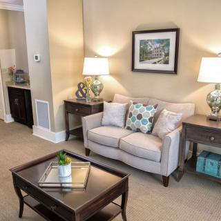 A cozy living room featuring a comfortable sofa, coffee table, and elegant lamps.