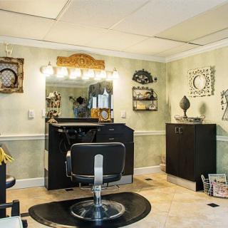 A cozy hair salon with a barber chair and well-lit styling station.