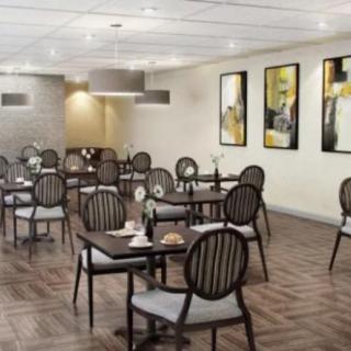 A modern cafe interior with neatly arranged tables and contemporary artwork.