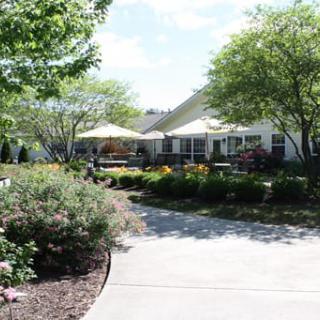 A scenic garden with a patio and lush green surroundings on a sunny day.