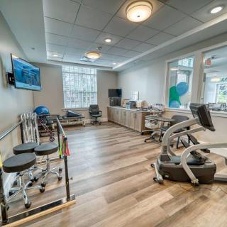 A well-equipped rehabilitation and physical therapy room with various exercise machines.