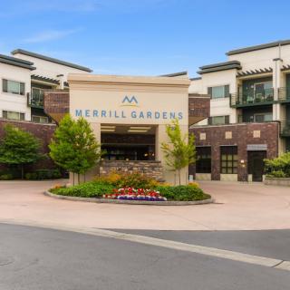 Entrance of a modern building with landscaped surroundings.