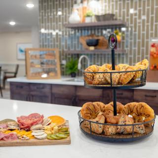 A delightful breakfast spread featuring freshly baked pastries and a colorful charcuterie board, set in a modern kitchen.
