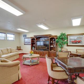 A cozy living room with a blend of classic furniture and modern amenities.