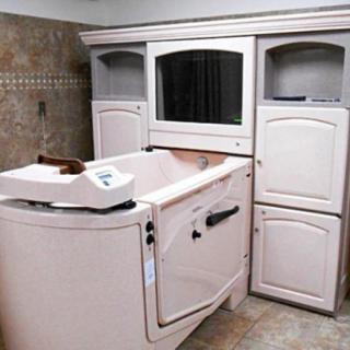 A walk-in bathtub designed for accessibility and safety in a bathroom setting.