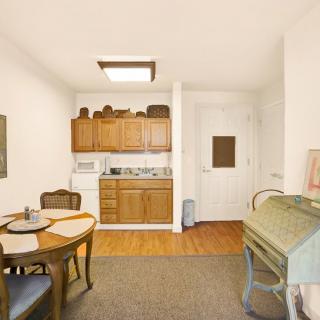 A cozy kitchen and dining area with wooden cabinets and a small dining table.