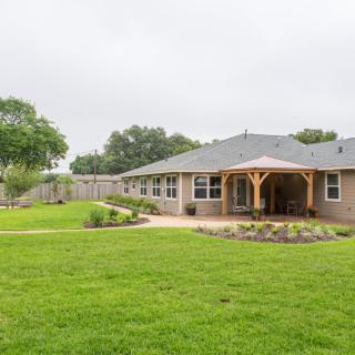 A suburban house with a spacious backyard and well-maintained lawn.