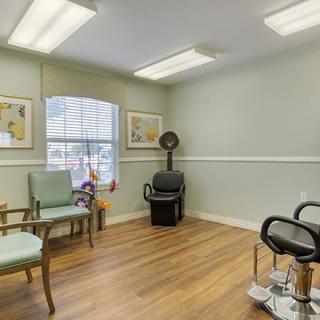 A cozy hair salon with seating and styling areas.