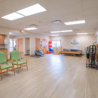 A spacious rehabilitation center equipped for physical therapy sessions.