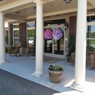 A welcoming entrance featuring decorative flower wreaths and elegant columns.