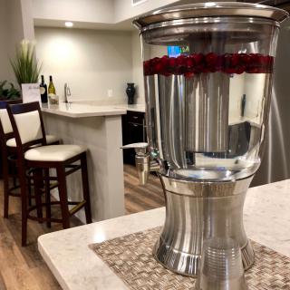 A chic kitchen with a stainless steel water dispenser on the countertop.