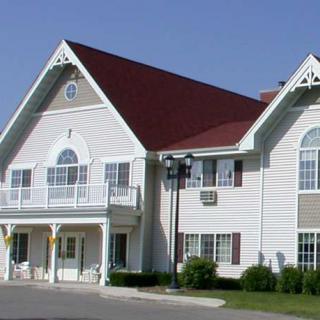 A two-story house with a red roof and white siding.