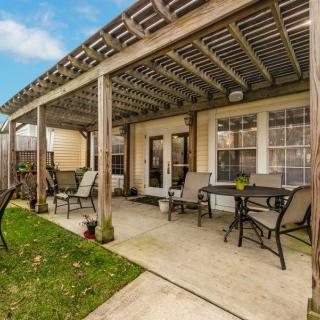 A cozy backyard patio with a pergola and outdoor seating.