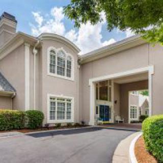 A modern residential building with a welcoming entrance and driveway.