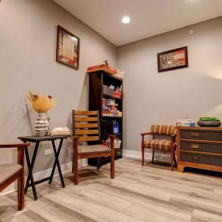 A cozy living room with wooden furniture and a bookshelf.