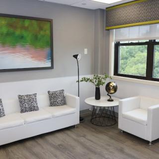 A modern office waiting area with comfortable seating and stylish decor.