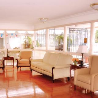 A bright and spacious living room with comfortable seating and wooden floors.