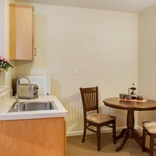A cozy kitchenette with a small dining table for two.