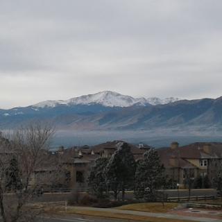 A serene view of snow-capped mountains under a cloudy sky.