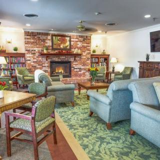 A cozy living room with comfortable seating and a brick fireplace.