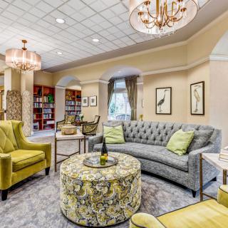 Elegant living room with stylish seating and chandeliers.