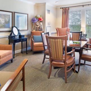 A cozy living room with comfortable chairs, a table, and soft lighting.