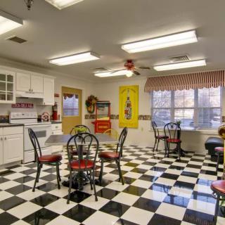 A retro-style diner kitchen with a black and white checkered floor.