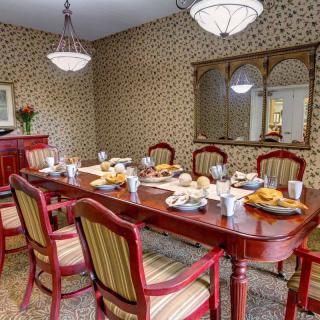 A cozy dining room with a set table and elegant decor.