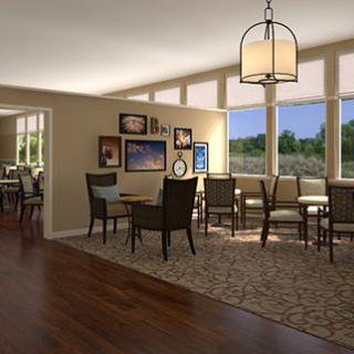 A cozy dining area with large windows and elegant decor.
