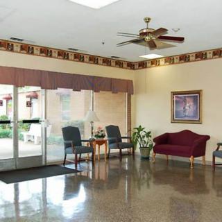A spacious lobby area with seating and a ceiling fan.