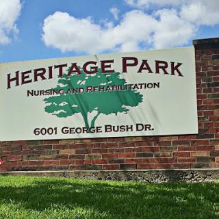 Heritage Park sign indicating a facility for rehabilitation located on George Bush Drive.