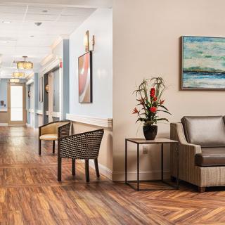 A modern hallway with a comfortable seating area and decorative elements.