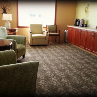 A cozy waiting room with comfortable seating and a coffee station.