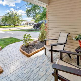 A cozy porch with chairs and a small garden area, perfect for relaxing.