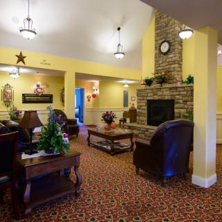 A cozy living room with comfortable seating and a brick fireplace.