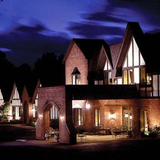 A beautifully lit residential building showcasing elegant architectural design at night.