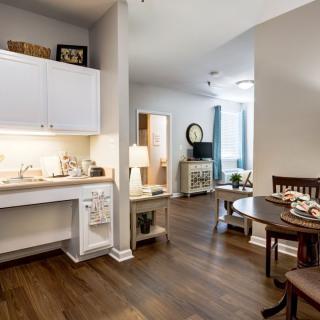 A cozy and modern interior featuring a small kitchen and dining area.