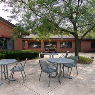 A serene outdoor seating area surrounded by greenery.