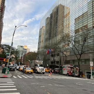 A busy NYC street scene with taxis and tall buildings.