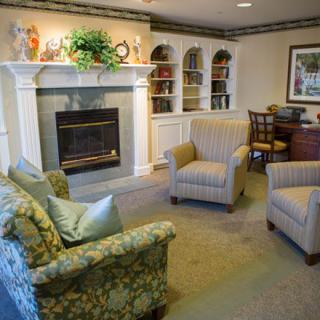 A cozy living room featuring comfortable seating and a fireplace.